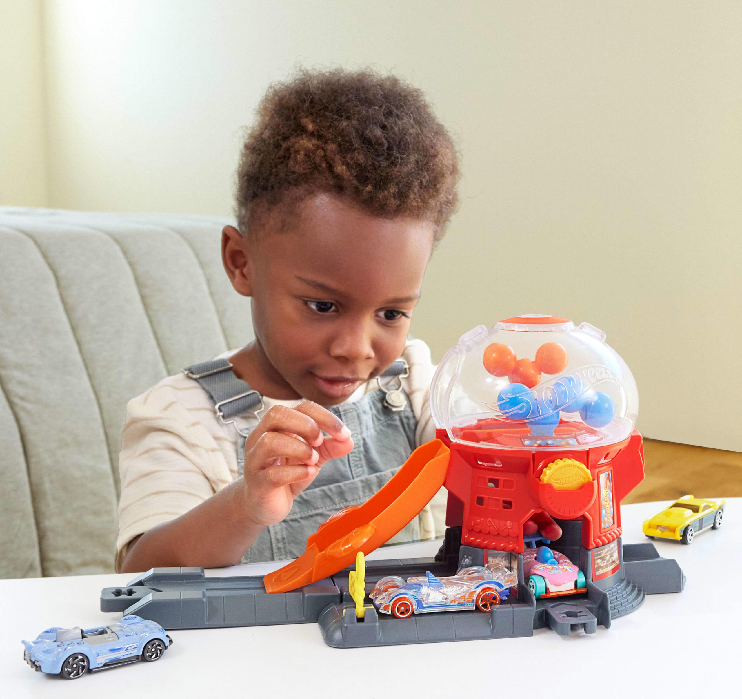 Hot Wheels Toy Car Track Set, Gumball Machine Playset with 1:64 Scale Die-Cast Donut-Shaped Vehicle & Speed Snap Track, Downtown City Candy Shop - Image 3